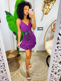 Abito corto viola glitter con gonna asimmetrica
