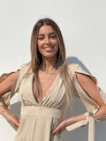 Tutina beige con fiocchetti