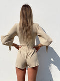 Tutina beige con fiocchetti