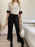 Pantalone nero con piume