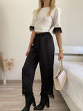 Pantalone nero con piume