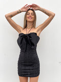 Abito con maxi fiocco e gonna in paillettes