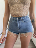 Short in jeans con frange in strass