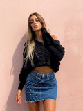 Gonna di jeans con borchie e trasparenze