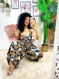 Tuta floreale con pantalone a pieghine