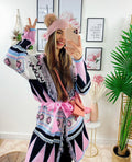 Cardigan rosa con frange e cinta