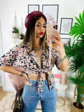 Blusa floreale con fiocco