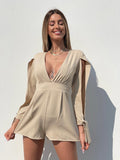 Tutina beige con fiocchetti