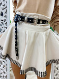 Short in ecopelle bianco con borchie