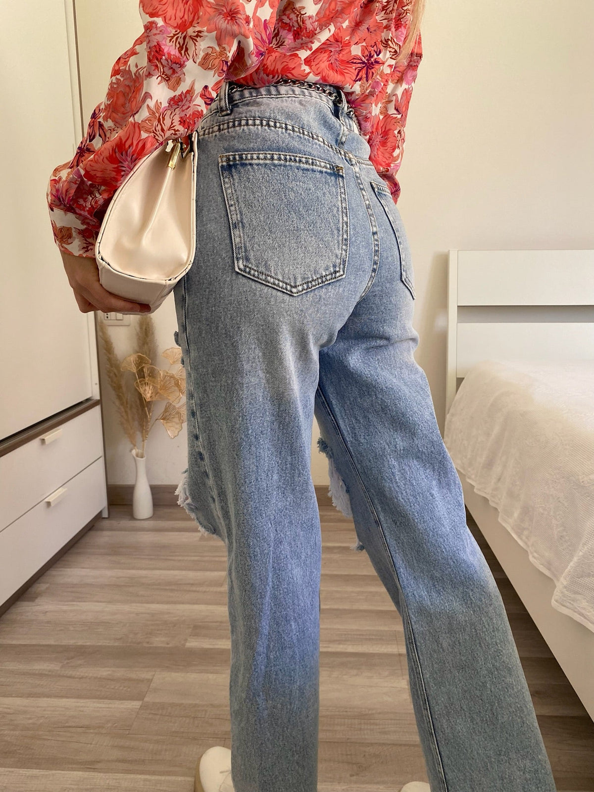 Jeans con strappi e cintura con catene