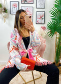 Cardigan A rombi bianco con frange e cinta