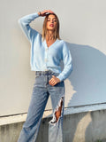 Maglione celeste con fiocchi gioiello